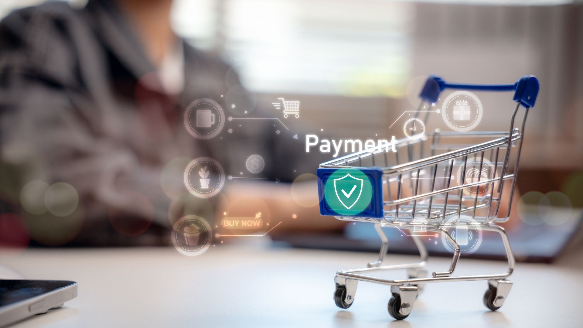 Online shopping cart with secure digital payment icon, illustrating e-commerce, buying behavior, secure checkout, mobile transaction, and modern retail technology in a digital economy.
